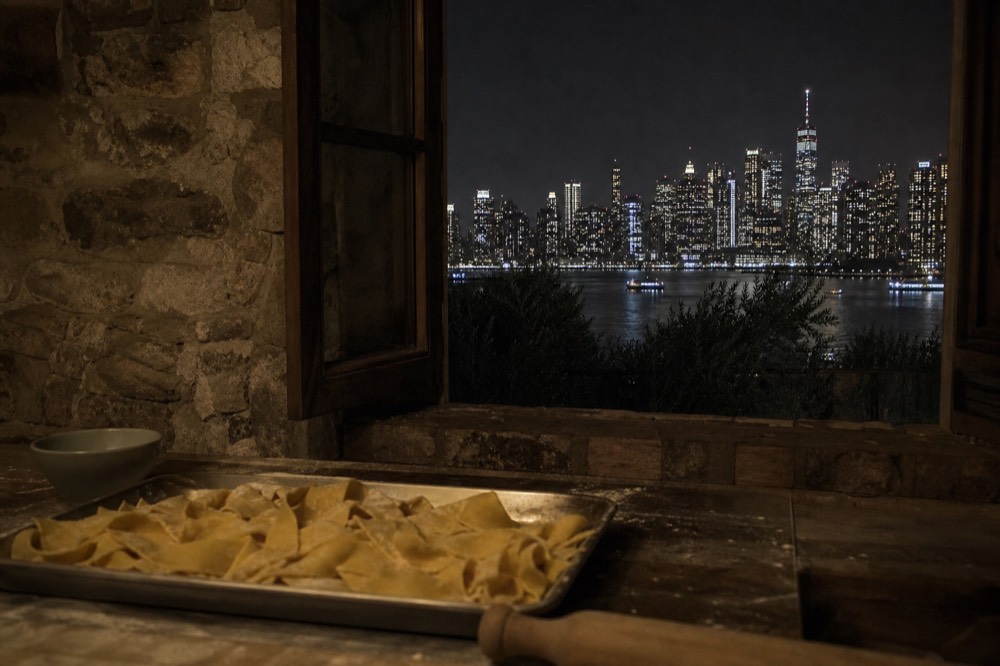 Stone farmhouse kitchen, open window over olive trees, a tray of hand-cut pappardelle